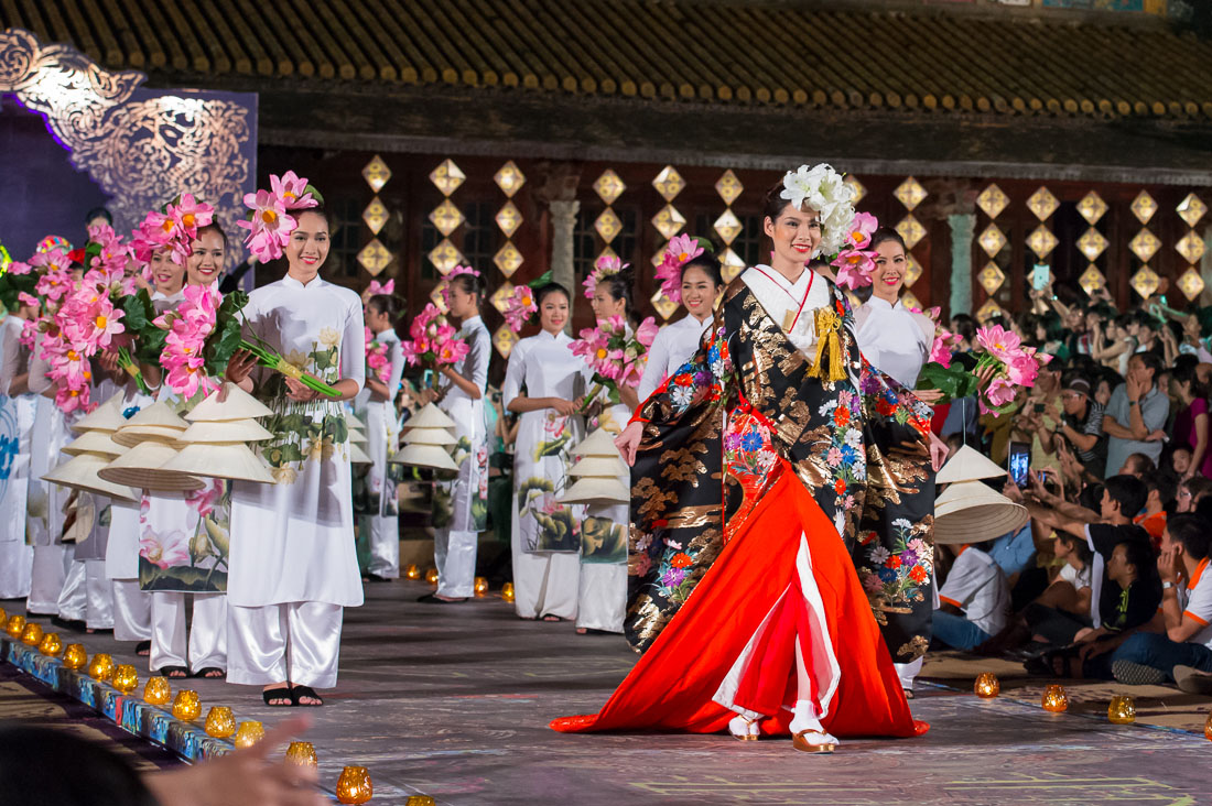 Vietnamese model wearing a Japanese kimono with models in the traditional dress from Viet Nam the ao dai, during the Oriental Night at Hue Festival 2014, Thua ThienâHue Province, Viet Nam, Indochina, South East Asia.
