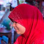 A young and beautiful Cham Muslim female butcher, wearing her hijab and selling beef meat at the Sen Monorom market, Mondulkiri province. Kingdom of Cambodia, Indochina, South East Asia