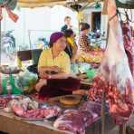 A young and beautiful Cham Muslim female butcher selling beef meat at the Ban Lung market, Ratanakiri province. Kingdom of Cambodia, Indochina, South East Asia