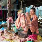 Selling pig heads at the market in Siem Reap; Kingdom of Cambodia, Indochina, South East Asia.