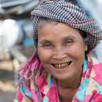 Woman smiling at the Stung Treng market, Stung Treng province, showing left over of the blackned teeth tradition. Kingdom of Cambodia, Indochina, South East Asia