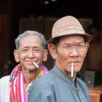 Two men smoking a cigarette in early morning, Sra Yong, Siem Reap province. Kingdom of Cambodia, Indochina, South East Asia