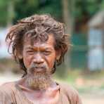 Very strange person walikng barefoot along the highway. Kingdom of Cambodia, Indochina, South East Asia