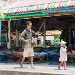 This blind musician is guided by his small daughter, they are connected by a thin rope. Sihnoukville, Kampong Saom province, Kingdom of Cambodia, Indochina, South East Asia