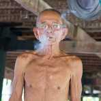 This old man is 90, very happy, he smokes 'only' 5 cigarettes a day and he is in extremely good health. Kompong Chan, Kingdom of Cambodia, Indochina, South East Asia.