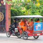 Buddhist monks getting a ride on a moto taxi, Ounalom pagoda. Phnom Penh, Kingdom of Cambodia, Indochina, South East Asia