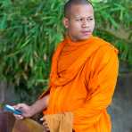 A Buddhist monk with his cellular phone, Ounalom pagoda. Phnom Penh, Kingdom of Cambodia, Indochina, South East Asia