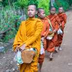 Younk Buddhist monks collecting food offers from people, Kompong Chan province. Kingdom of Cambodia, Indochina, South East Asia