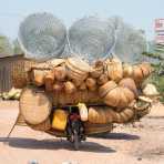 A scooter fully loaded with bamboo baskets. Kingdom of Cambodia, Indochina, South East Asia.