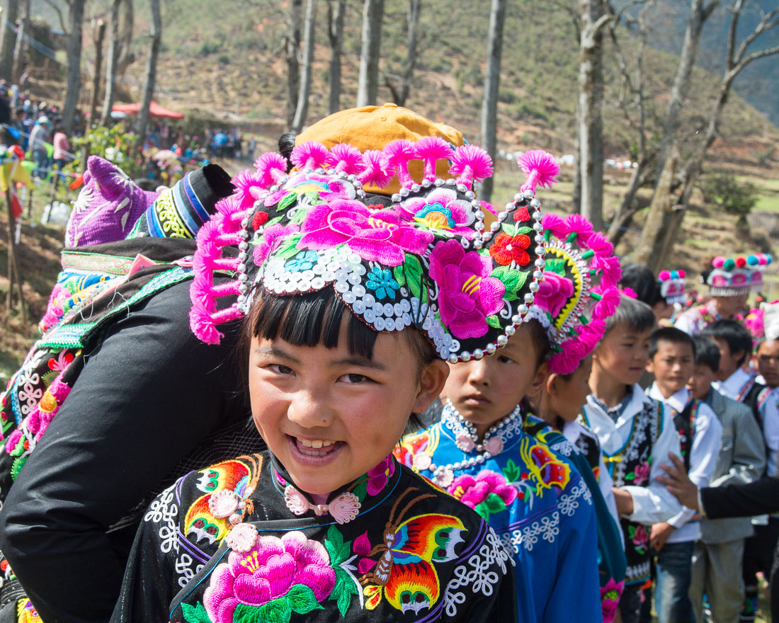 Little girl wearing the traditional costume of the Yi ethnic minority people, at the annual costume festival at Zhi Ju village, Yong Ren County, Yunnan Province, China, Asia. Nikon D4, 24-120mm, f/4.0, VR