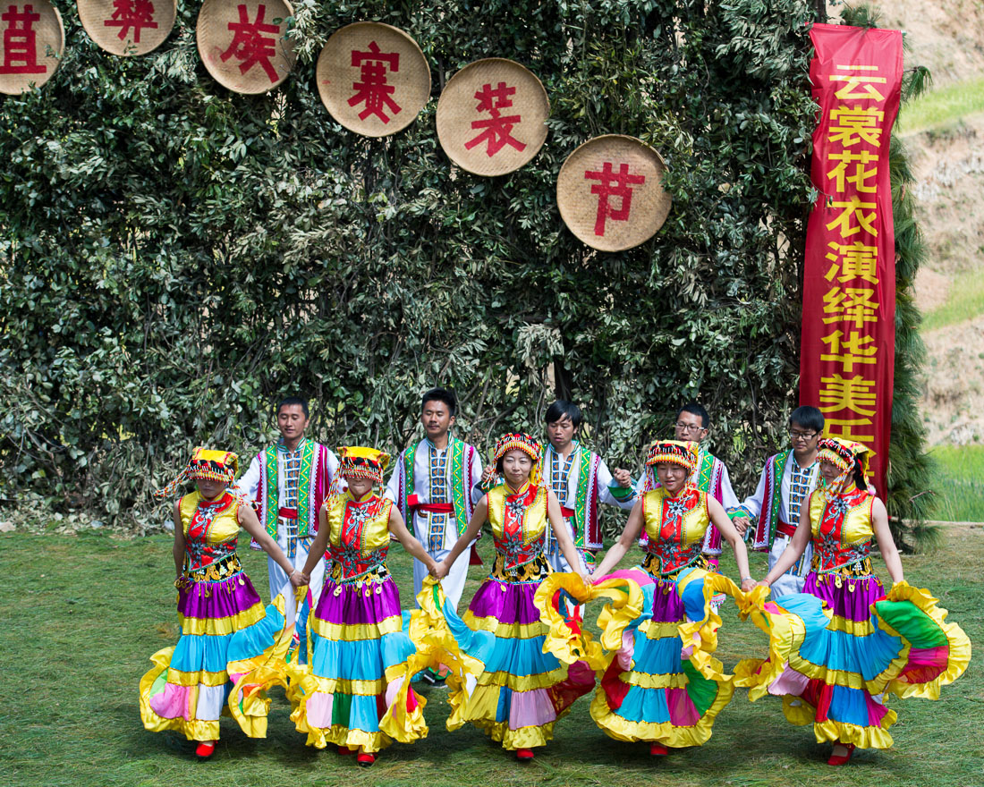 Men and women from the Yi ethnic minority people, performing traditional dance, wearing traditional colorful costumes at the annual festival in Zhi Ju village, Yong Ren County, Yunnan Province, China, Asia. Nikon D4, 70-200mm, f/2.8, VR II