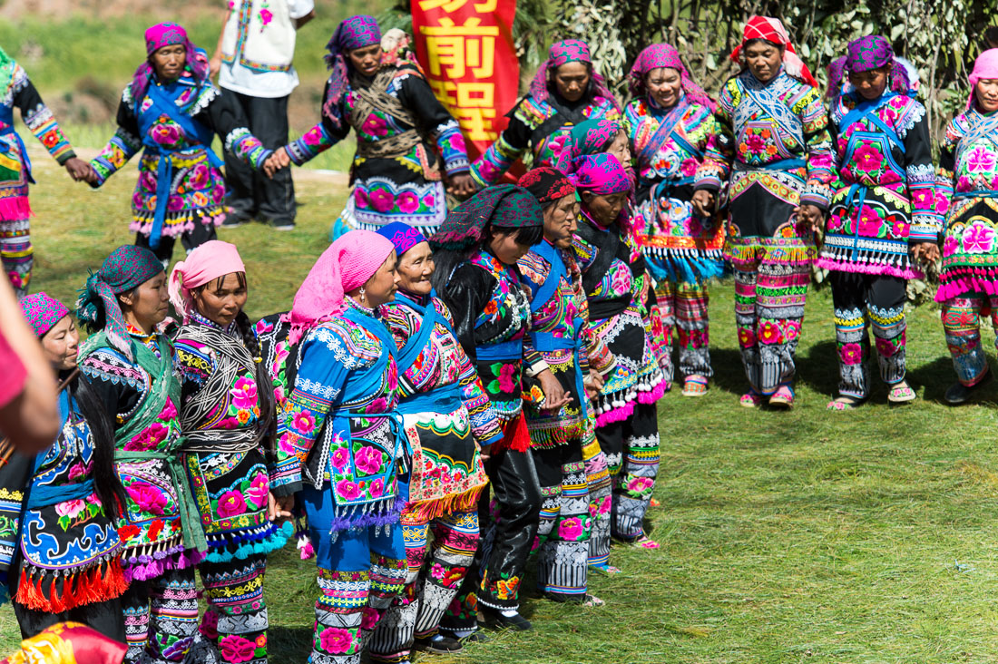 Women from the Yi ethnic minority people, in traditional colorful costume, dancing at the annual festival in Zhi Ju village, Yong Ren County, Yunnan Province, China, Asia. Nikon D4, 70-200mm, f/2.8, VR II