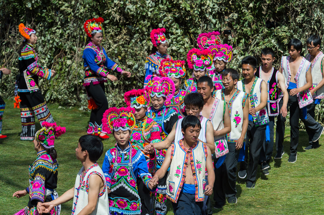 Boys and girls from the Yi ethnic minority people, in traditional colorful costume, performing at the annual festival in Zhi Ju village, Yong Ren County, Yunnan Province, China, Asia. Nikon D4, 70-200mm, f/2.8, VR II