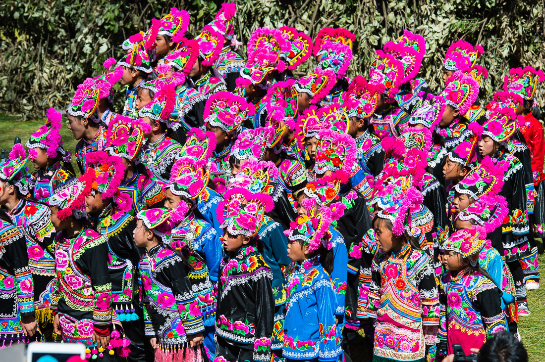 Girls from the Yi ethnic minority people, in traditional colorful costume, performing at the annual festival in Zhi Ju village, Yong Ren County, Yunnan Province, China, Asia. Nikon D4, 70-200mm, f/2.8, VR II