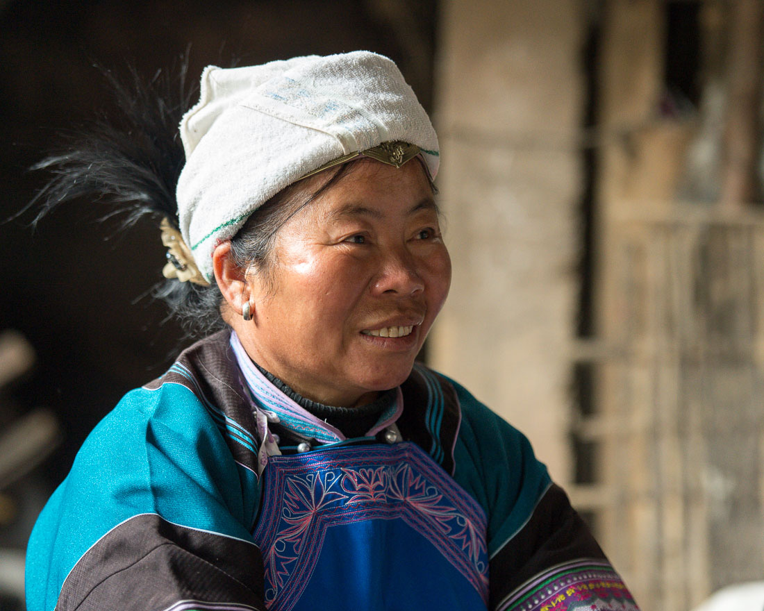 A woman from the Bu Yi ethnic minority people, in traditional costume. La Zhe village, Luo Ping County, Yunnan Province, China, Asia. Nikon D4, 70-200mm, f/2.8, VR II