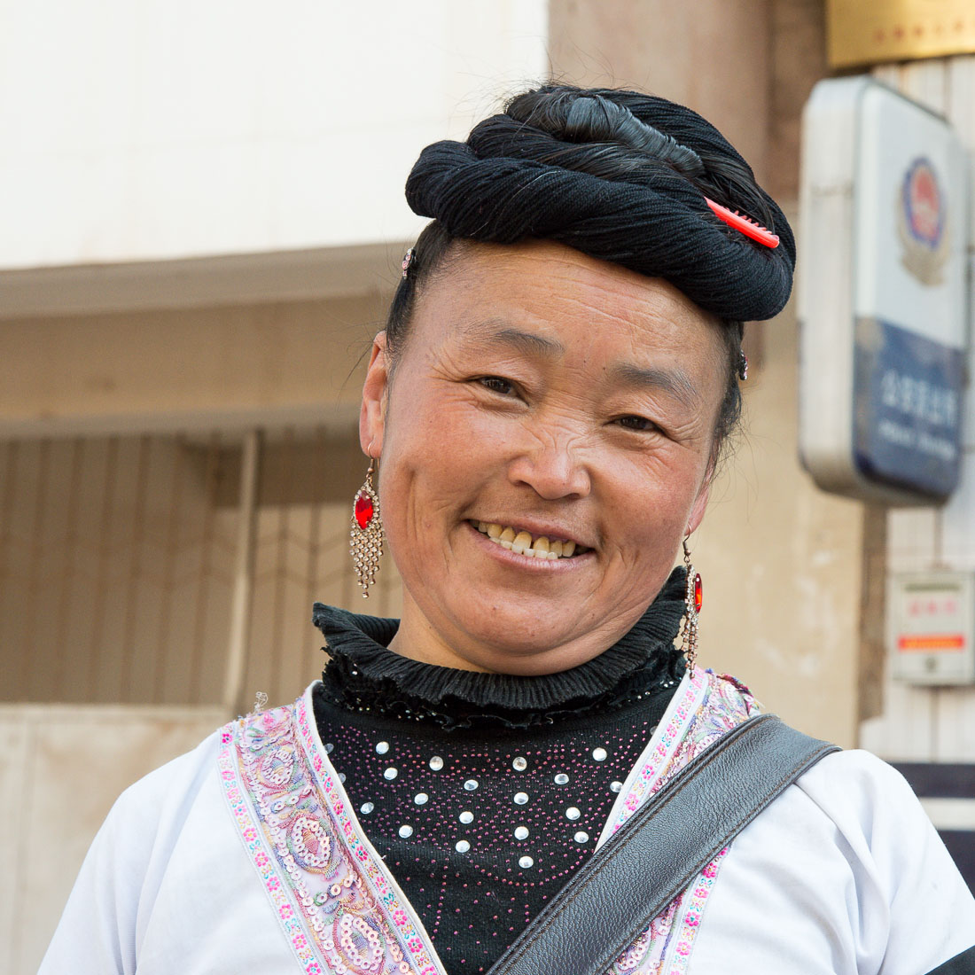 A traditional hair arrangement from the women of the Miao ethnic minority people. Mao Jie market, Wuding County, Yunnan Province, China, Asia. Nikon D4, 24-120mm, f/4.0, VR