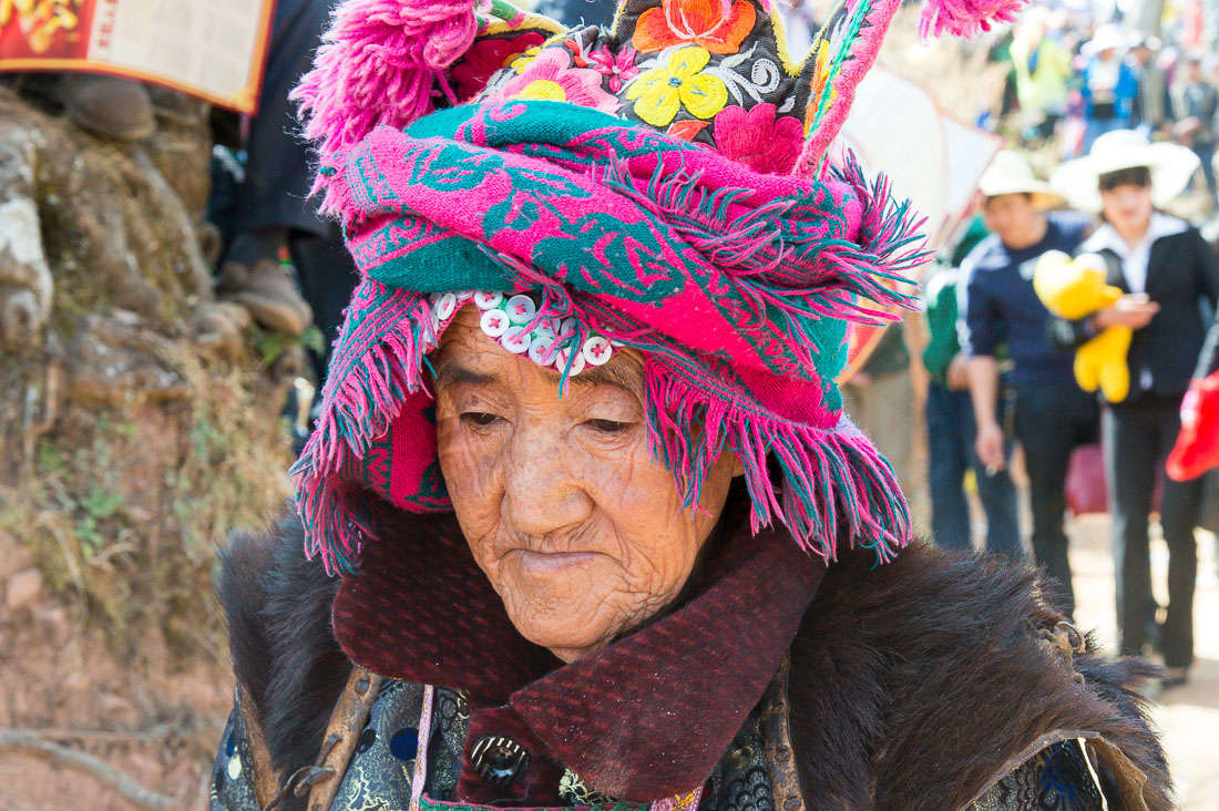 An old woman from the Yi ethnic minority people, wearing the traditional costume at the annual festival in Zhi Ju village. Yong Ren County, Yunnan Province, China, Asia. Nikon D4, 24-120mm, f/4.0, VR