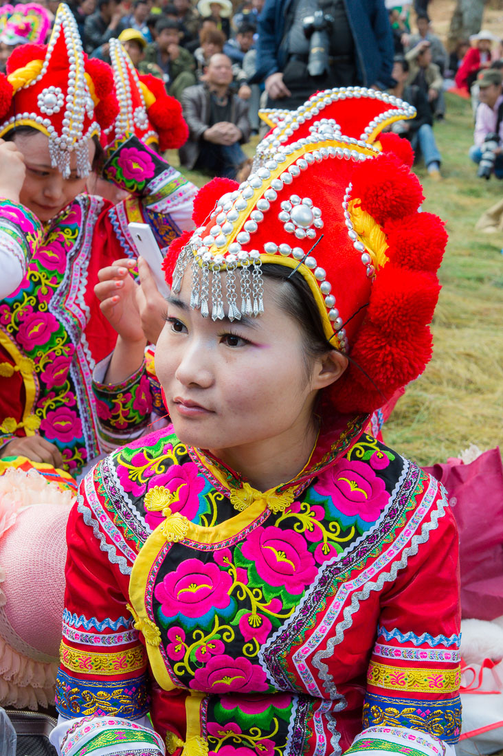 Colorful costumes of the Yi ethnic minority people, at the annual festival in Zhi Ju village. Yong Ren County, Yunnan Province, China, Asia. Nikon D4, 24-120mm, f/4.0, VR