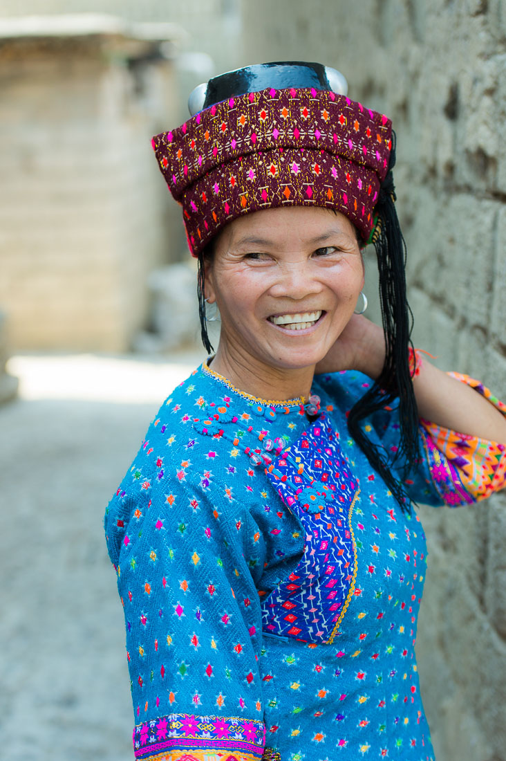A joyful woman from the Dai ethnic minority people wearing the traditional costume. Zhe Ga village, Yuan Jing County, Yunnan Province, China, Asia. Nikon D4, 24-120mm, f/4.0, VR