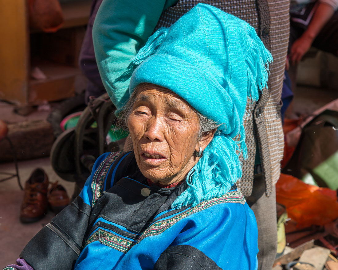Old woman from the Ha Ni ethnic minority people wearing the traditional costume at the market in Jia Yin village. Yunnan Province, China, Asia. Nikon D4, 24-120mm, f/4.0, VR
