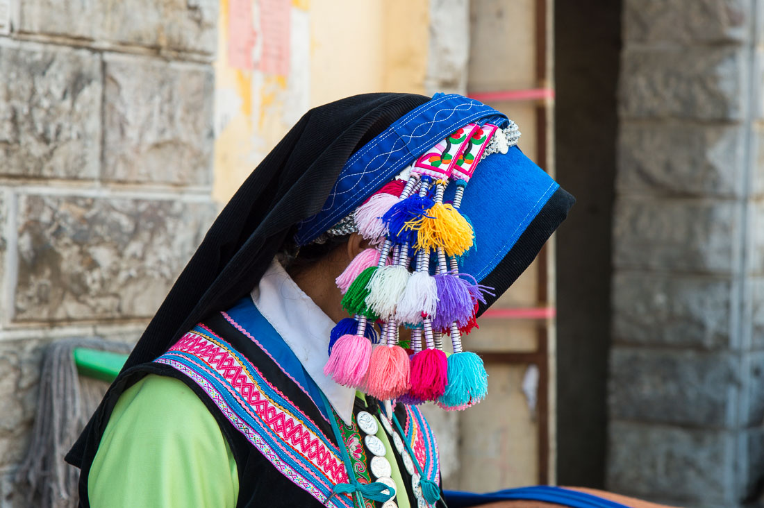 Colorful hat from the traditional costume worn by the women from the Yi ethnic minority people.  Yuang Yang market, Yunnan Province, China, Asia. Nikon D4, 24-120mm, f/4.0, VR