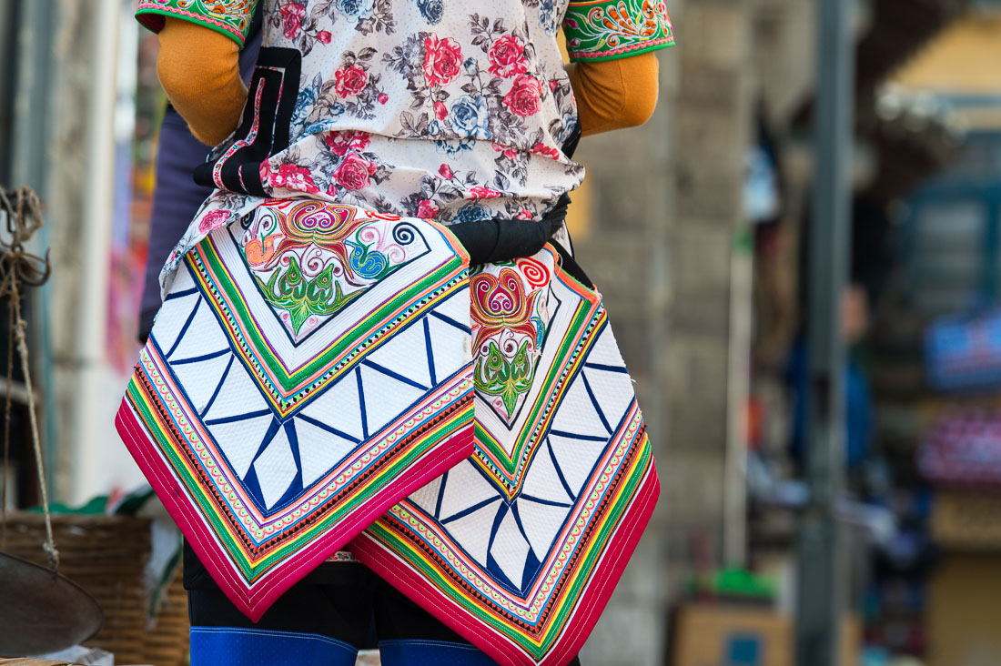 Particular from the traditional costume used by Yi ethnic minority people.  Market in Yuan Yang County, Yunnan Province, China, Asia. Nikon D4, 70-200mm, f/2.8, VR II