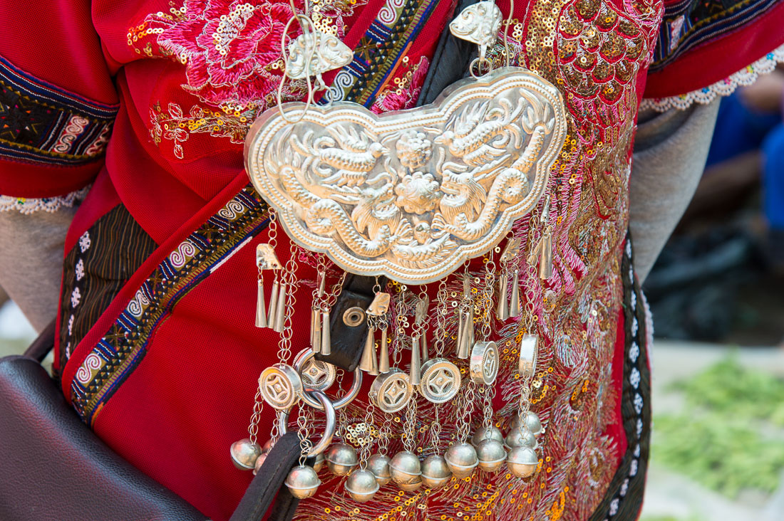 Silver pendants, part of the traditional costume from the Miao ethnic minority people. Sha La Tuo market, Yunnan Province, China, Asia. Nikon D4, 24-120mm, f/4.0, VR