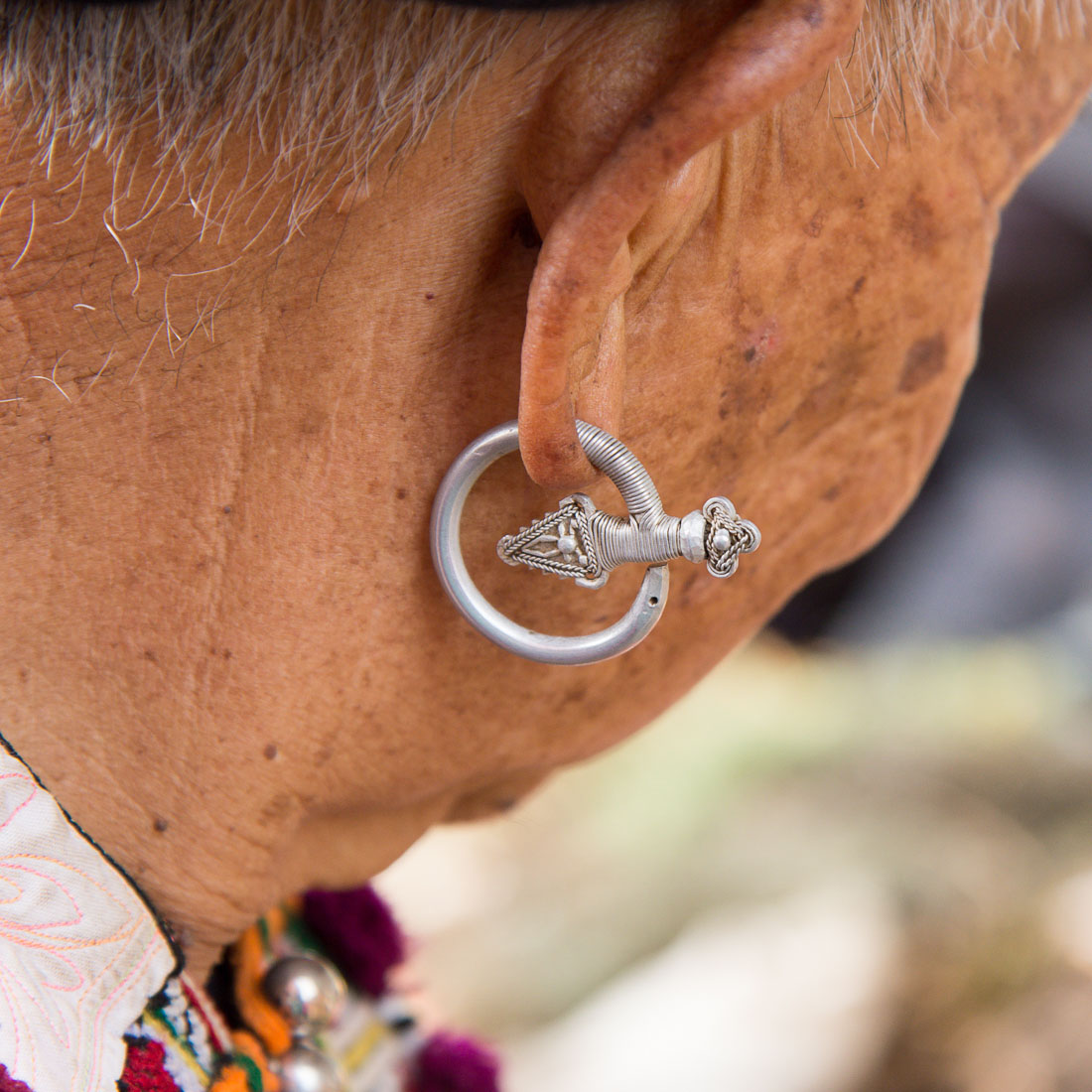 Traditional earring worn by the women from the Yao ethnic minority people. Jin Ping market, Yunnan Province, China, Asia. Nikon D4, 24-120mm, f/4.0, VR