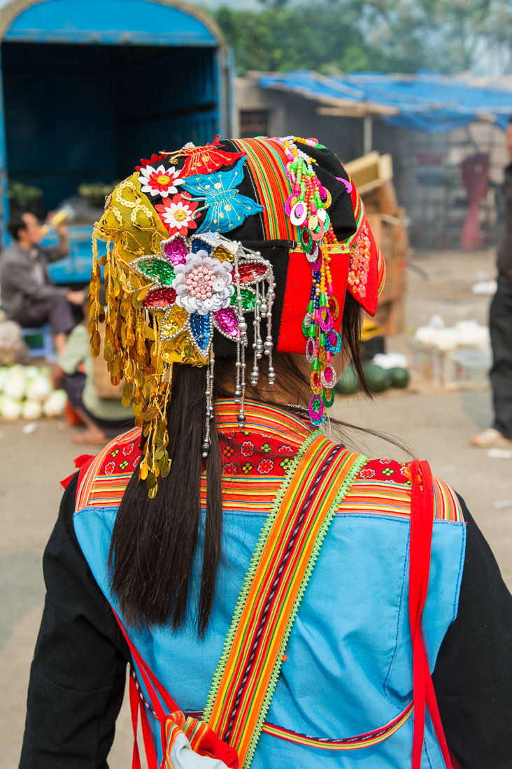 Traditional costume worn by the women from the Yao ethnic minority people. Jin Shui He market, Jin Ping County, Yunnan Province, China, Asia. Nikon D4, 24-120mm, f/4.0, VR