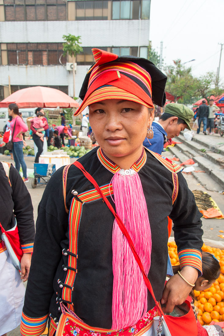 A beautiful woman from the Yao ethnic minority people wearing the traditional costume. Jin Shui He market, Jin Ping County, Yunnan Province, China, Asia. Nikon D4, 24-120mm, f/4.0, VR