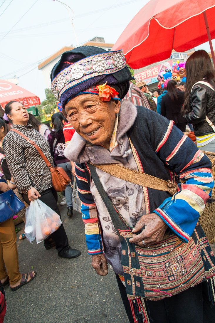 An old woman from the Ha Ni ethnic minority people in traditional costume. Mang Xin market, Meng Lian County, Yunnan Province, China, Asia. Nikon D4, 24-120mm, f/4.0, VR