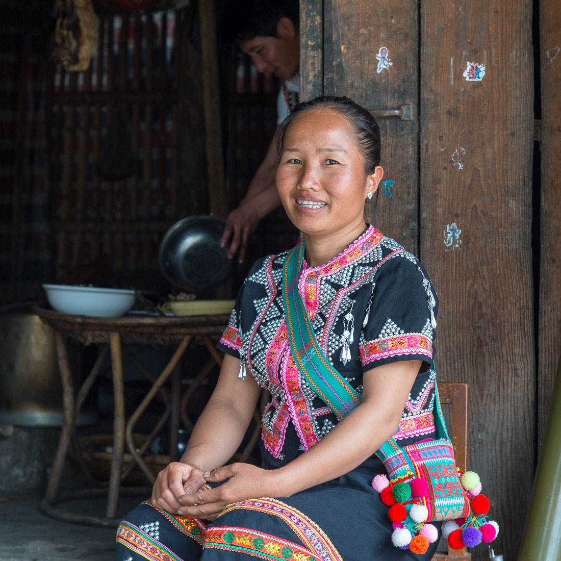 A joyful young woman from the La Hu ethnic minority people, proudly wearing the treditional costume. Lao Ba Village, Lan Cang County, Yunnan Province, China, Asia. Nikon D4, 24-120mm, f/4.0, VR