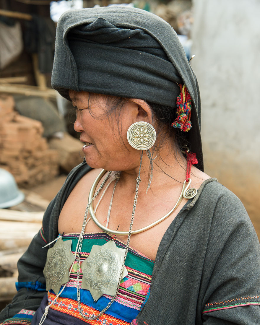 A woman from the A Ke ethnic minority people, in treditional costume, wearing silver jewlery. A Ke Village, Meng Hai County, Yunnan Province, China, Asia. Nikon D4, 24-120mm, f/4.0, VR