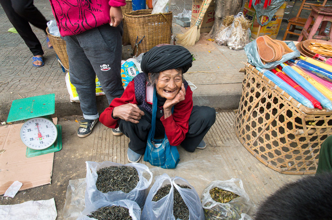 A joyful old woman selling tea at the Lan Chang market, Yunnan Province, China, Asia. Nikon D4, 24-120mm, f/4.0, VR