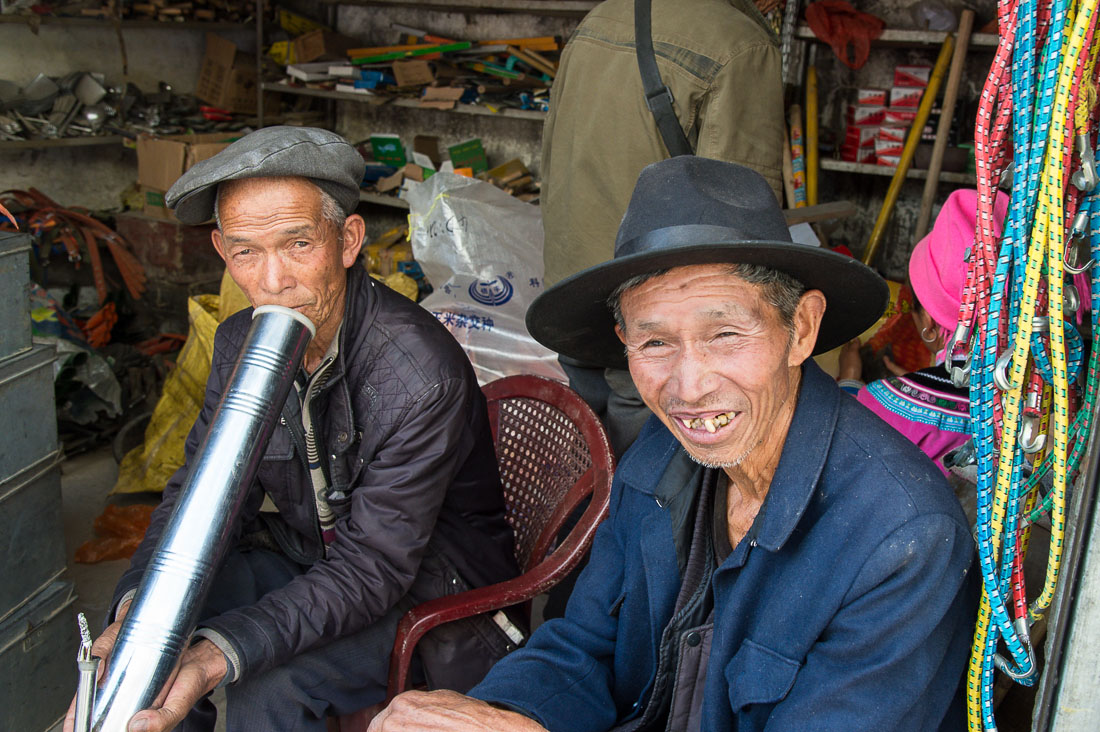 Two men taking a break at Jia Yin market, Yunnan Province, China, Asia. Nikon D4, 24-120mm, f/4.0, VR