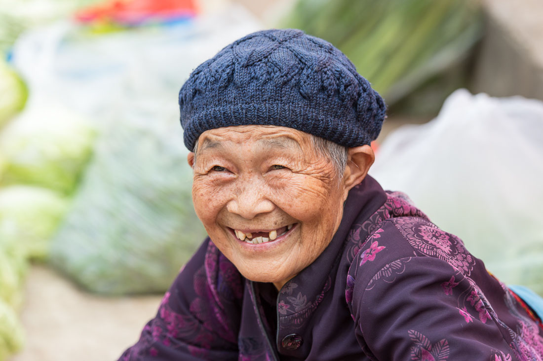 An old and joyful woman at Jin Shui market, Jin Ping County, Yunnan Province, China, Asia. Nikon D4, 70-200mm, f/2.8, VR II