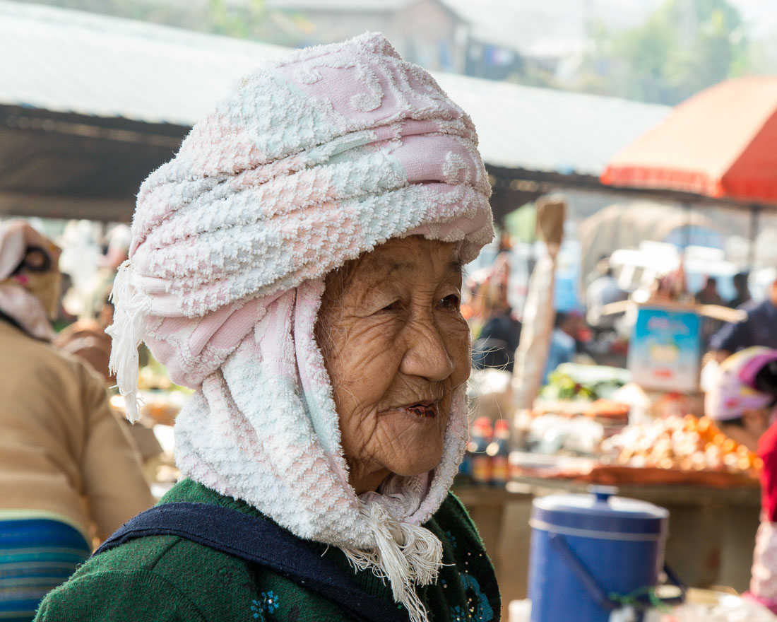 A very old woman from the Dai ethnic minority people. The market at Mang Xin, Meng Lian County, Yunnan Province, China, Asia. Nikon D4, 24-120mm, f/4.0, VR