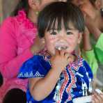 Little boy wearing the traditional costume of the La Hu ethnic minority people, Loa Ba Dao village, Lan Cang county, Yunnan Province, China, Asia. Nikon D4, 24-120mm, f/4.0, VR