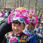 Little girl wearing the traditional costume of the Yi ethnic minority people, at the annual costume festival at Zhi Ju village, Yong Ren County, Yunnan Province, China, Asia. Nikon D4, 24-120mm, f/4.0, VR