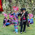 A man and a woman from the Yi ethnic minority people, playing a primitive musical instrument, in traditional colorful costumes at the annual festival in Zhi Ju village, Yong Ren County, Yunnan Province, China, Asia. Nikon D4, 70-200mm, f/2.8, VR II