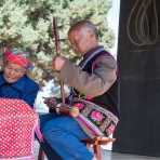 An old musician from the Miao ethnic minority people, playing an ancient string musical instrument. Mao Jie village, Wuding County, Yunnan Procince, China, Asia. Nikon D4, 24-120mm, f/4.0, VR