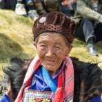 An old woman from the Yi ethnic minority people, wearing the traditional costume at the annual festival in Zhi Ju village. Yong Ren County, Yunnan Province, China, Asia. Nikon D4, 24-120mm, f/4.0, VR