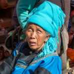 Old woman from the Ha Ni ethnic minority people wearing the traditional costume at the market in Jia Yin village. Yunnan Province, China, Asia. Nikon D4, 24-120mm, f/4.0, VR
