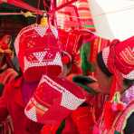 Colorful hats worn by the women from the Pu La Yi ethnic minority people, on sale at the Xi Bei Le market, Meng Zi city, Yunnan Province, China, Asia. Nikon D4, 24-120mm, f/4.0, VR