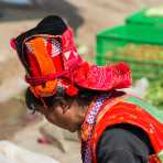 Colorful hat worn by the women from the Pu La Yi ethnic minority people, at the Xi Bei Le market, Meng Zi city, Yunnan Province, China, Asia. Nikon D4, 70-200mm, f/2.8, VR II