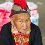 An old woman from the Yao ethnic minority people wearing the traditional costume. Jin Ping market, Yunnan Province, China, Asia. Nikon D4, 70-200mm, f/2.8, VR II