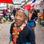 A joyful woman from the Yao ethnic minority people, in traditional costume, smiling at the photographer. Jin Ping market, Yunnan Province, China, Asia. Nikon D4, 24-120mm, f/4.0, VR