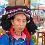 A joyfull woman from the Yi ethnic minority people, wearing the traditional costume,  at Jin Shui He market, Jin Ping County, Yunnan Province, China, Asia. Nikon D4, 24-120mm, f/4.0, VR