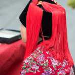 Colorful and unusual hat worn by the women from the Ha Ni ethnic minority people. Ping He market,, Lu Chun County, Yunnan Province, China, Asia. Nikon D4, 70-200mm, f/2.8, VR II