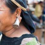 A woman from the Bulang ethnic minority people wearing the unique traditional earring. Mang Xin market, Meng Lian County, Yunnan Province, China, Asia. Nikon D4, 70-200mm, f/2.8, VR II